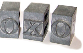 Typesetting blocks forming the letters O, X and O