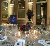 Internal photo of venue showing tables laid out for diner.